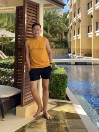 Rear view of young man standing in swimming pool