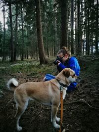 Rear view of man with dog in forest