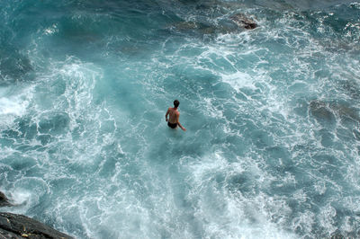 High angle view of man swimming in sea