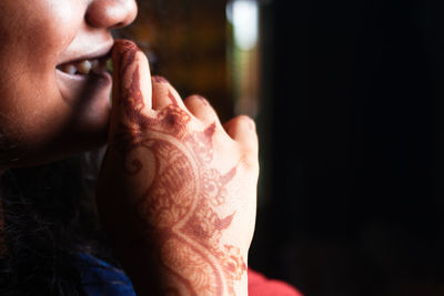 Close-up of woman with henna tattoo