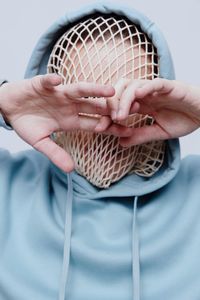 Cropped hand of man holding seashell