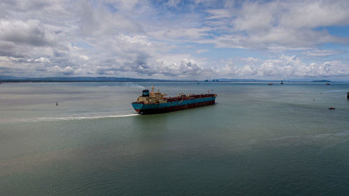 Boat sailing in sea against sky