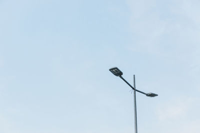 Low angle view of windmill against blue sky