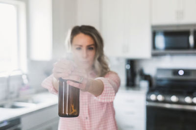 Portrait of woman drinking water from bottle