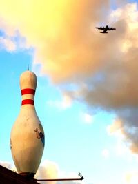 Low angle view of airplane flying against sky