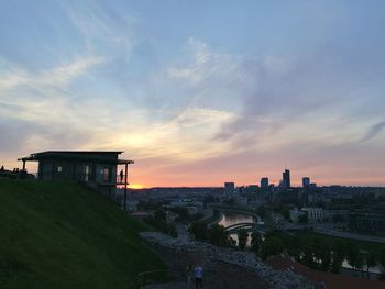 View of cityscape against cloudy sky