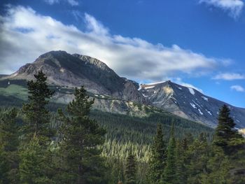 Scenic view of mountains against cloudy sky