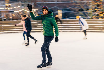 Full length of people on snow in park