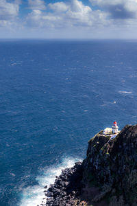 High angle view of sea and rocks against sky