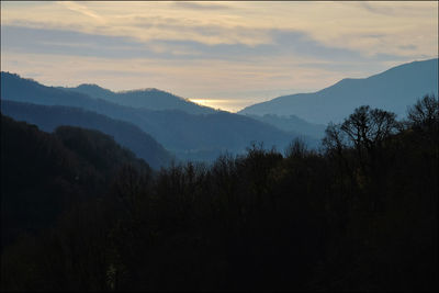 Scenic view of silhouette mountains against sky at sunset