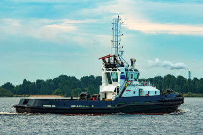 Ship sailing in sea against sky
