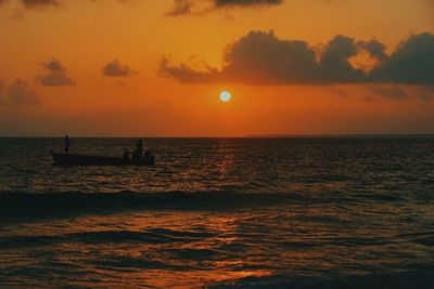 Scenic view of sea against orange sky