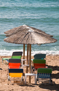 Chairs on beach against sea