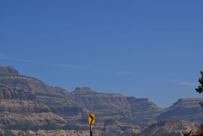 Man standing on mountain against clear sky