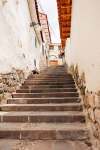 Low angle view of steps amidst buildings