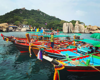 Boats moored on beach against sky