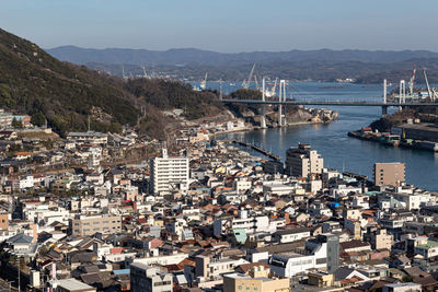 High angle view of townscape and harbor against sky