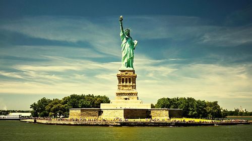 Low angle view of statue against cloudy sky