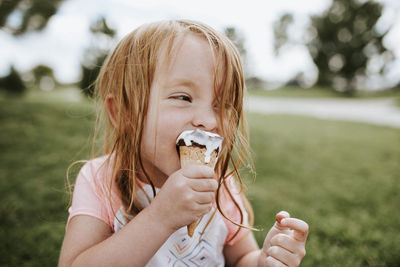 Close-up of girl eating ice cream in park