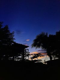 Low angle view of silhouette trees against sky at night