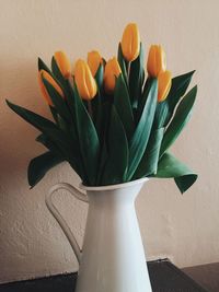 Tulips in vase on table at home