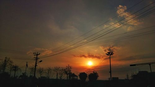 Silhouette trees against sky during sunset