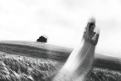 Blurred motion of man on field against sky