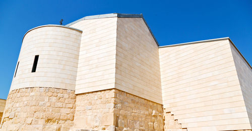 Low angle view of building against clear blue sky