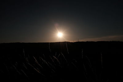 Silhouette landscape against sky during sunset