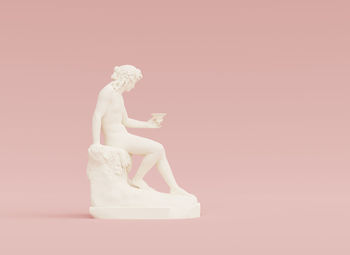 Close-up of statue against pink background