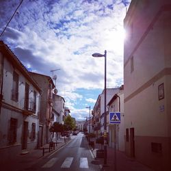 Street amidst buildings in city against sky