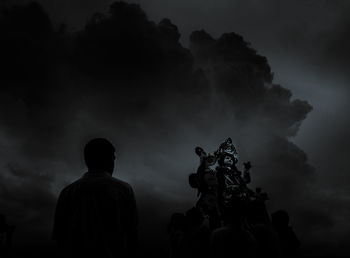 Rear view of silhouette statue against sky