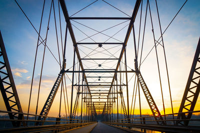 Low angle view of bridge against sky during sunset