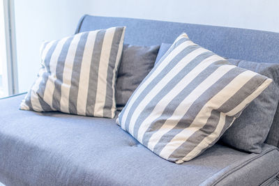 Low section of woman relaxing on sofa at home