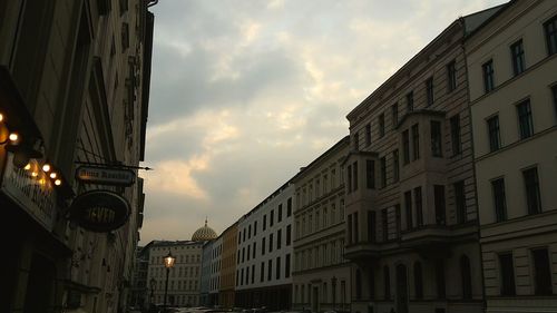 Low angle view of building against cloudy sky