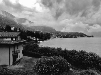 Scenic view of lake by buildings against sky