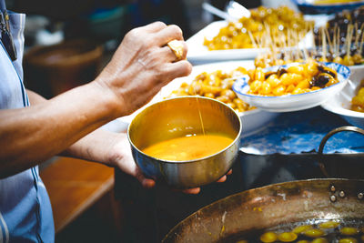 Midsection of person preparing food