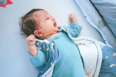 High angle view of baby sleeping in bed