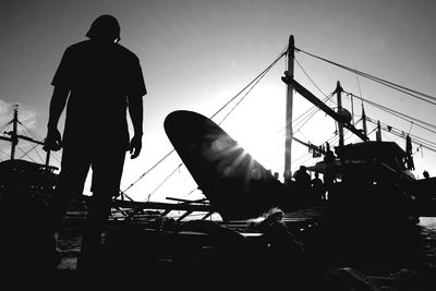 Low angle view of silhouette man against clear sky