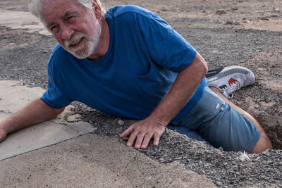 High angle portrait of man sitting outdoors