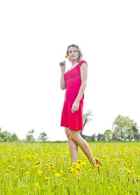 Full length of woman standing on field against sky