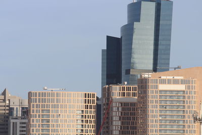 Low angle view of modern buildings against clear sky