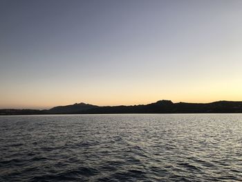 Scenic view of sea against clear sky during sunset