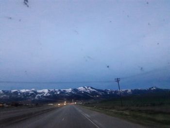 Road by mountain against sky