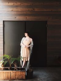 Woman in dress standing in front of double doors