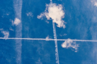 Low angle view of vapor trail against blue sky