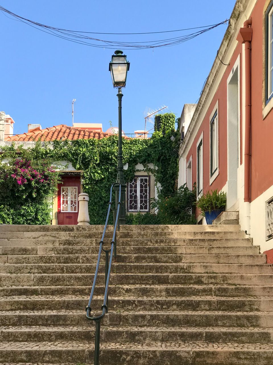 LOW ANGLE VIEW OF STREET LIGHT BY BUILDING