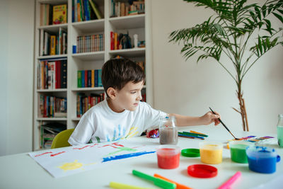 Boy looking at table