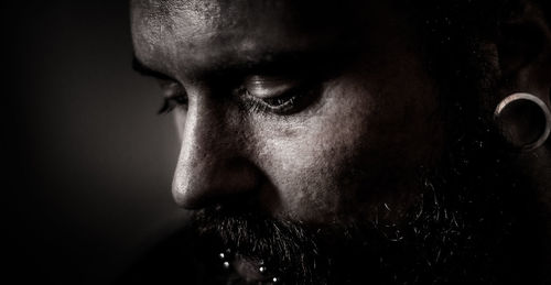 Close-up of mid adult man against black background