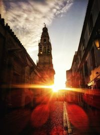 Sunlight with lens flare over old buildings